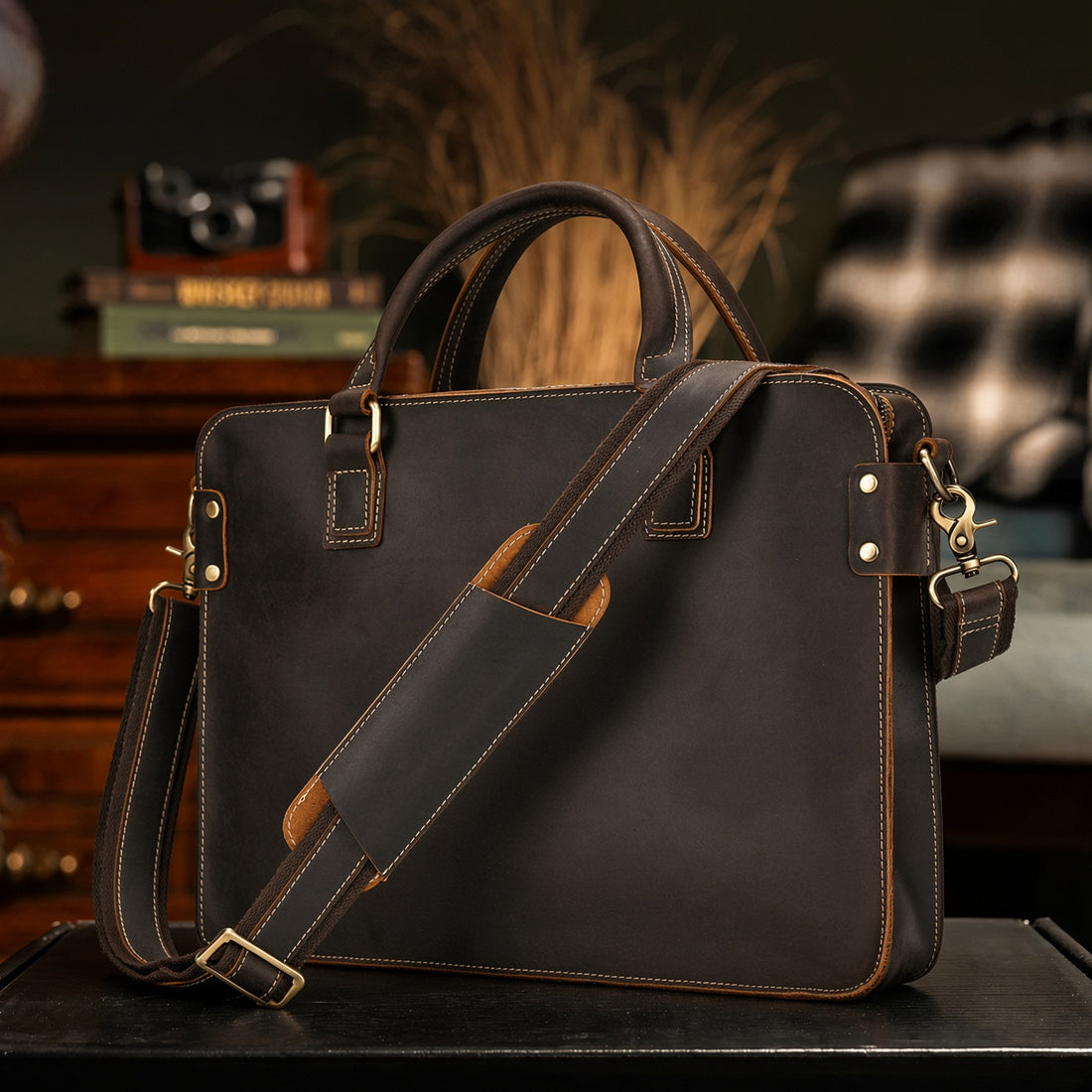 Dark Brown vintage-style briefcase with two top handles and a shoulder strap on a table in a den